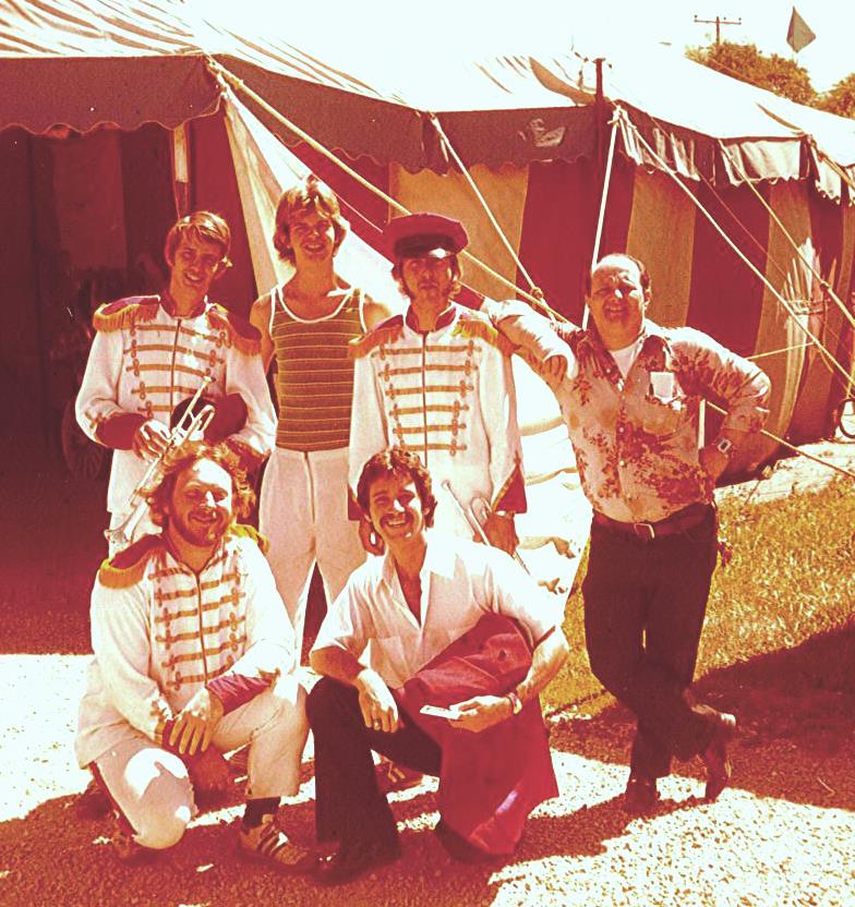 6 men dressed up and ready for the daily street parade from the 1960s.